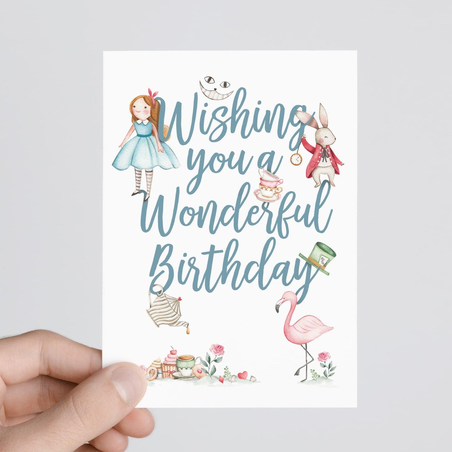 person holding Alice in wonderland birthday card