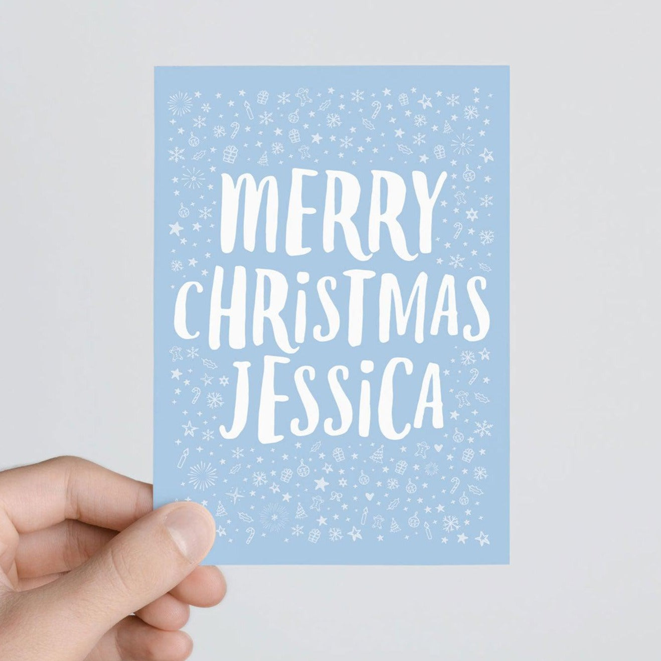 hand holding a Blue Personalised Merry Christmas Card